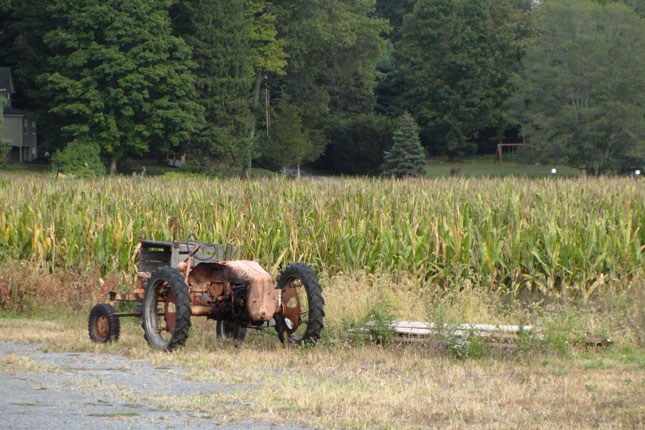 a tractor and a corn field